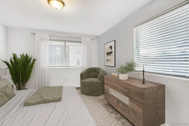 a backyard of a house with wooden fence and a ceiling fan