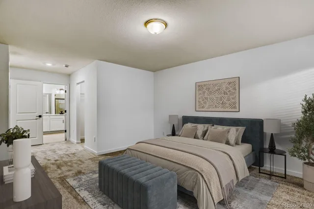 a bedroom with a bed and painting on the wall