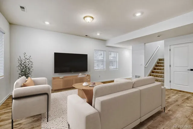 a living room with furniture kitchen and a table