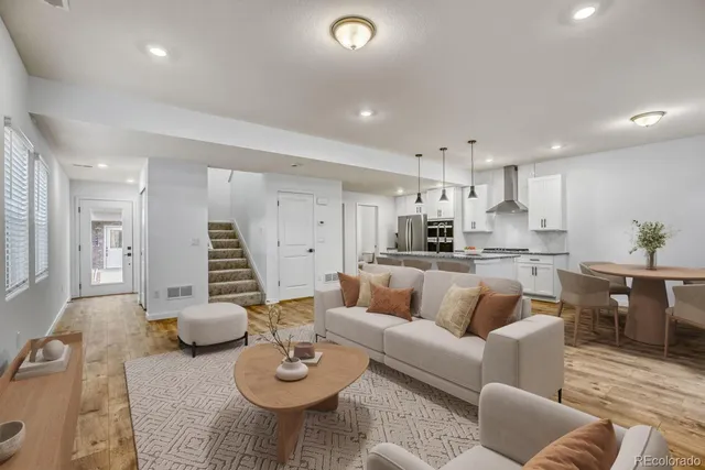 a kitchen with kitchen island a counter top space a sink and stainless steel appliances