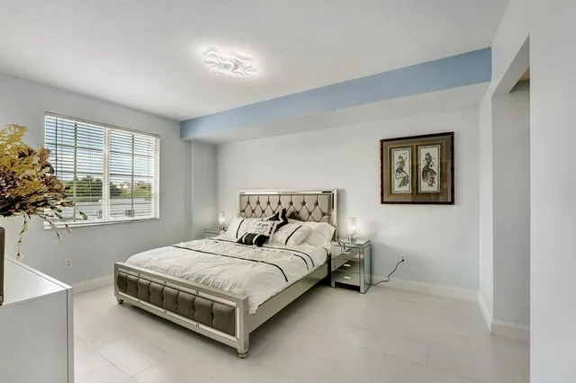 a bedroom with a bed and a lamp