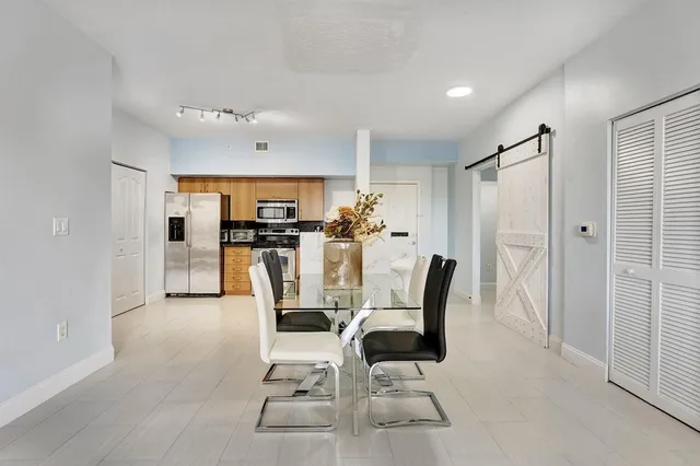 a large white kitchen with cabinets and stainless steel appliances