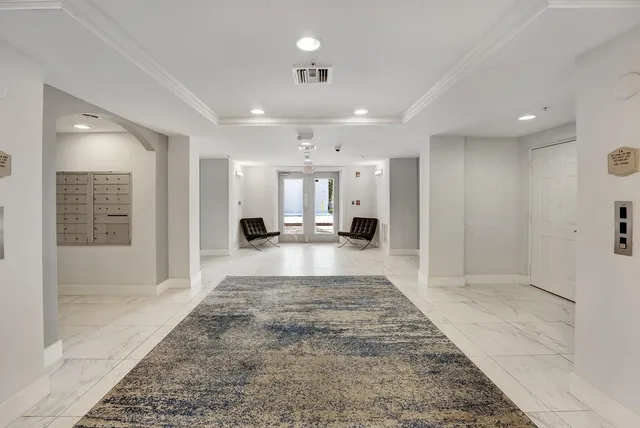 a view of a studio with a rug