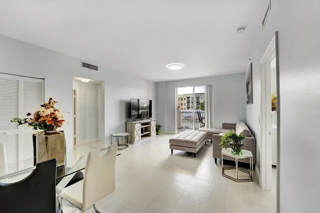 a kitchen with granite countertop a refrigerator and a sink