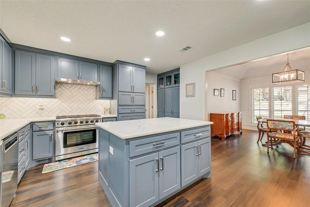 805 Crowley Road Arlington, TX 76012 - Photo 11 of 30 a kitchen with stainless steel appliances granite countertop a stove and a refrigerator
