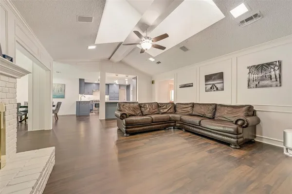 a living room with furniture or wooden floor and a rug