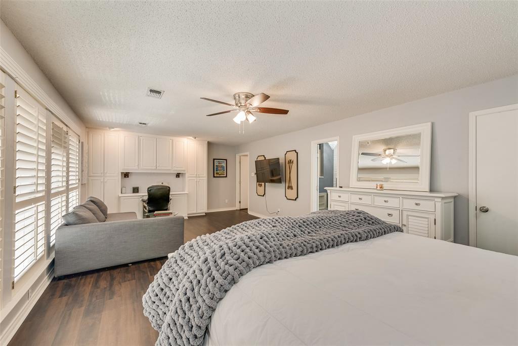 805 Crowley Road Arlington, TX 76012 - Photo 27 of 30 a spacious bedroom with a bed a couch and a window