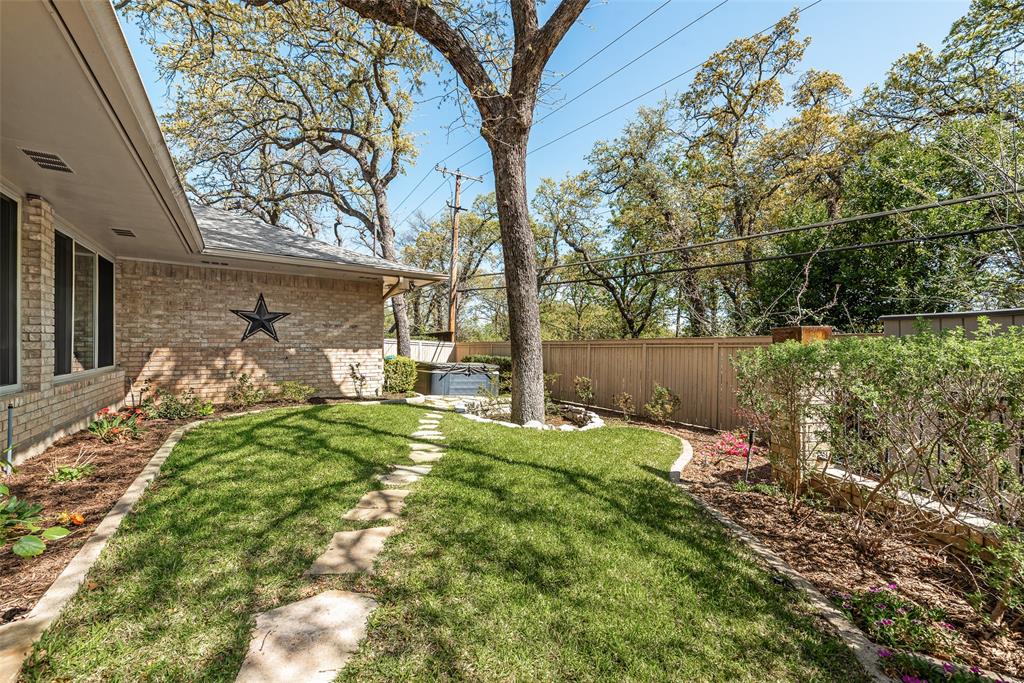 805 Crowley Road Arlington, TX 76012 - Photo 29 of 30 a backyard of a house with table and chairs