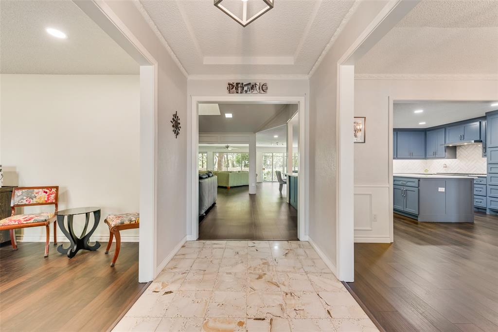 805 Crowley Road Arlington, TX 76012 - Photo 3 of 30 a view of a hallway to a livingroom with furniture and an entryway