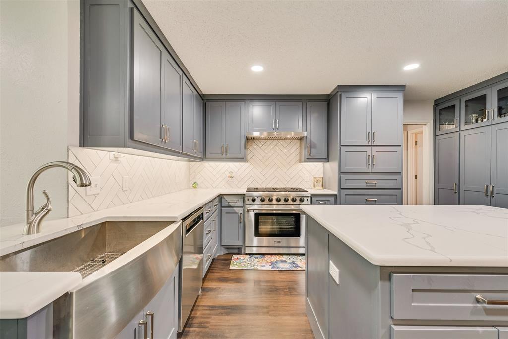 805 Crowley Road Arlington, TX 76012 - Photo 9 of 30 a kitchen with kitchen island granite countertop a sink stove and refrigerator