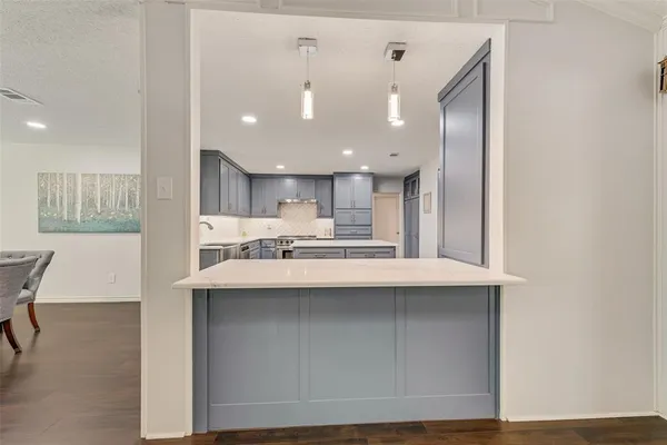 a kitchen with kitchen island a sink stainless steel appliances and cabinets