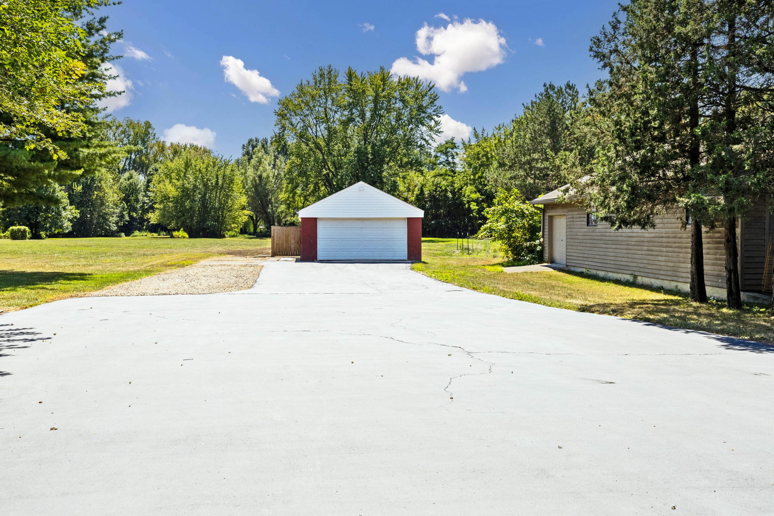 1213 East Cooke Road Columbus, OH 43224 - Photo 47 of 57 • Block & vinyl exterior • Service door • Electric door opener • Separate electric box tied to home • New garage door ~ 2014/2025 • Uninsulated