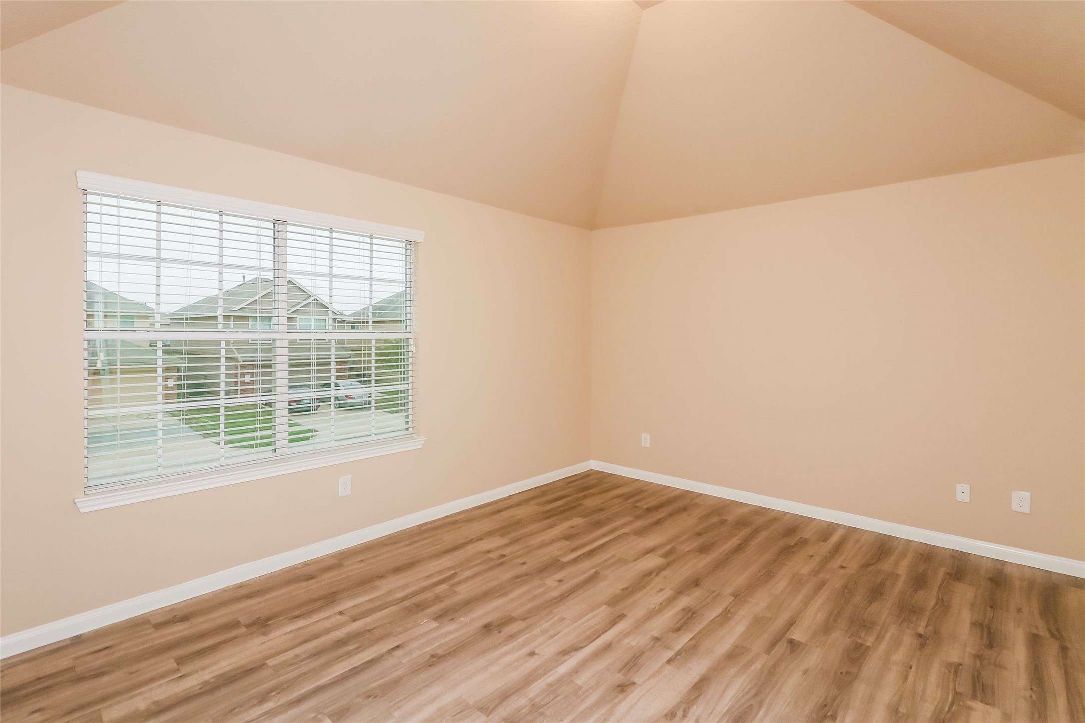 19006 Treviso Terrace Lane Katy, TX 77449 - Photo 11 of 17 a view of an empty room with wooden floor and a window