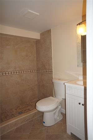 120 Navajo Road Springfield, MA 01109 - Photo 13 of 16 a white toilet sitting next to a bathroom sink and vanity