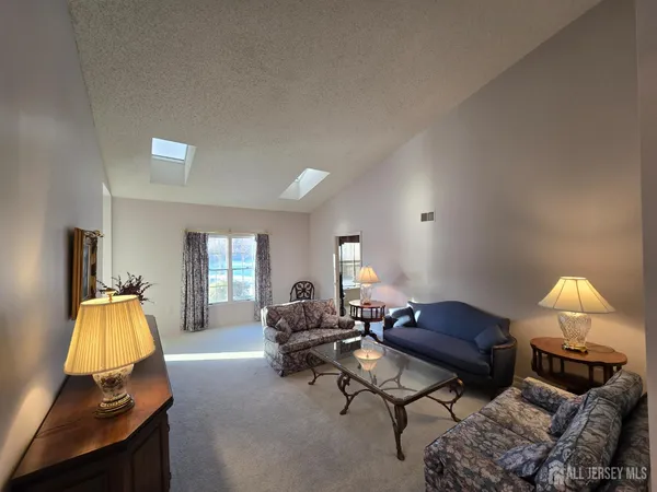 a living room with furniture and a lamp