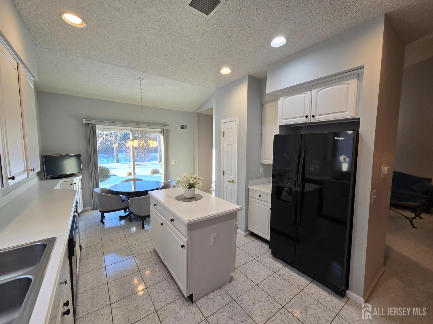 133 Chichester Road Monroe Township, NJ 08831 - Photo 3 of 25 a kitchen with a sink and refrigerator