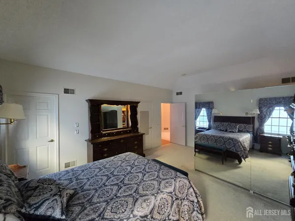 a bedroom with a bed and a couch