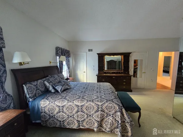 a bedroom with a bed and a television in it