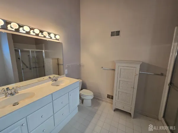 a bathroom with a sink a toilet and mirror