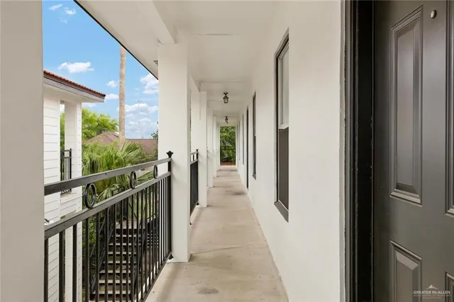 a kitchen with granite countertop white cabinets and refrigerator