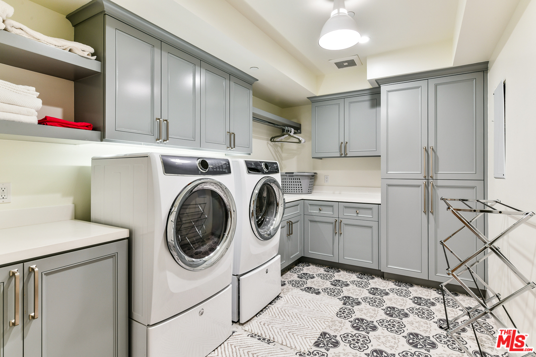 703 Bayview Drive Manhattan Beach, CA 90266 - Photo 21 of 24 a kitchen with stainless steel appliances granite countertop a sink a stove a refrigerator and cabinets