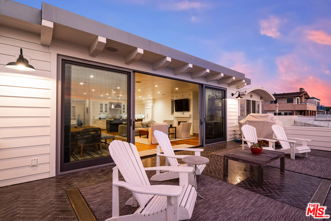 703 Bayview Drive Manhattan Beach, CA 90266 - Photo 6 of 24 a living room with couches a flat screen tv and balcony view
