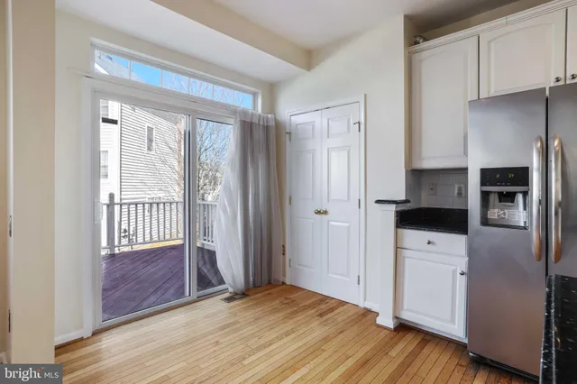 a view of kitchen with utility area and refrigerator