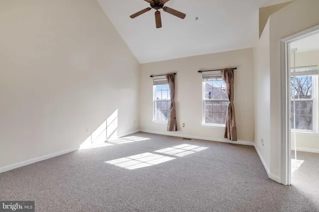 a view of livingroom with window and a ceiling fan