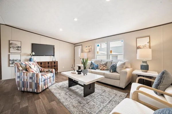 a living room with furniture and a flat screen tv