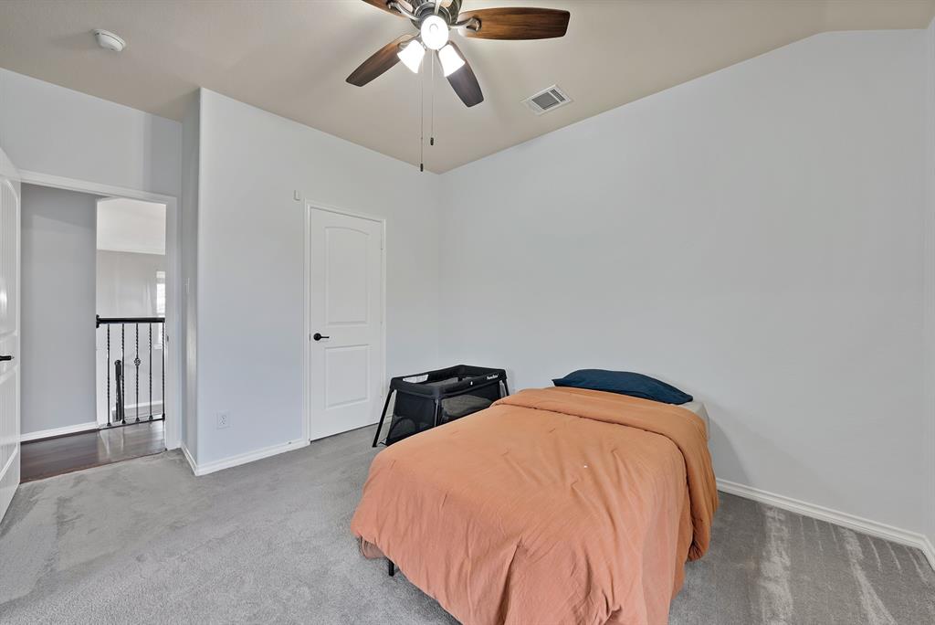 3822 Spring Run Lane Melissa, TX 75454 - Photo 32 of 39 a bedroom with a bed and chandelier
