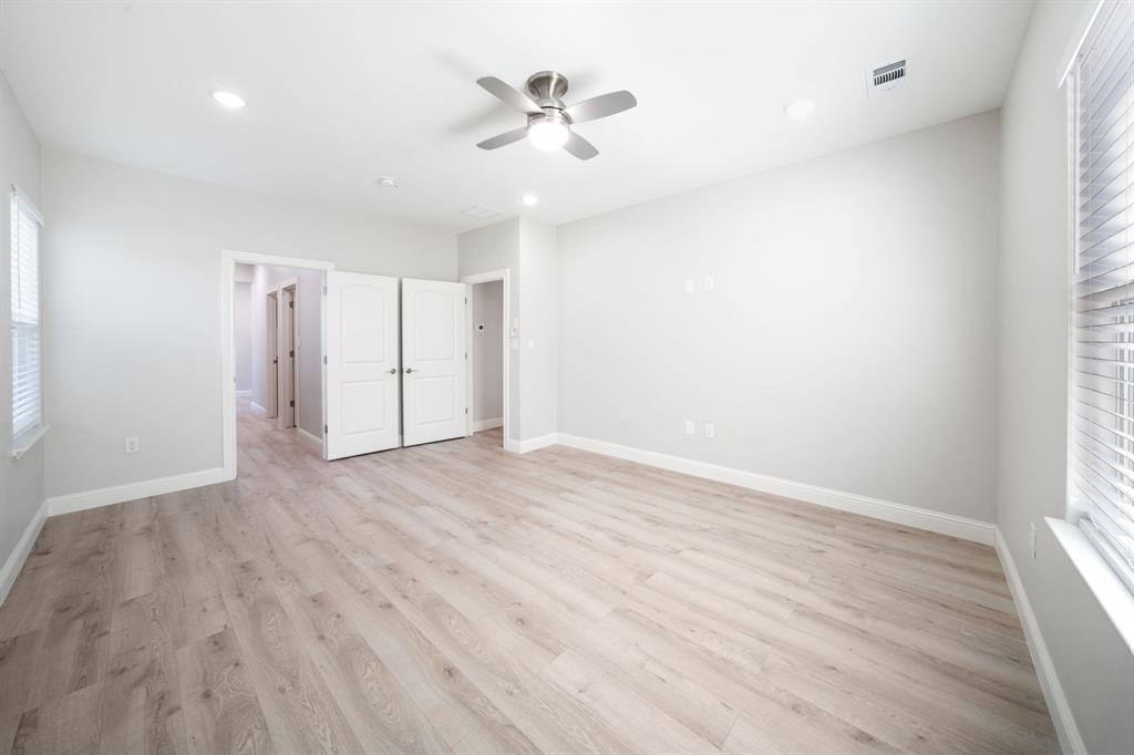 8809 Isom Lane Dallas, TX 75249 - Photo 15 of 40 wooden floor in an empty room with a window