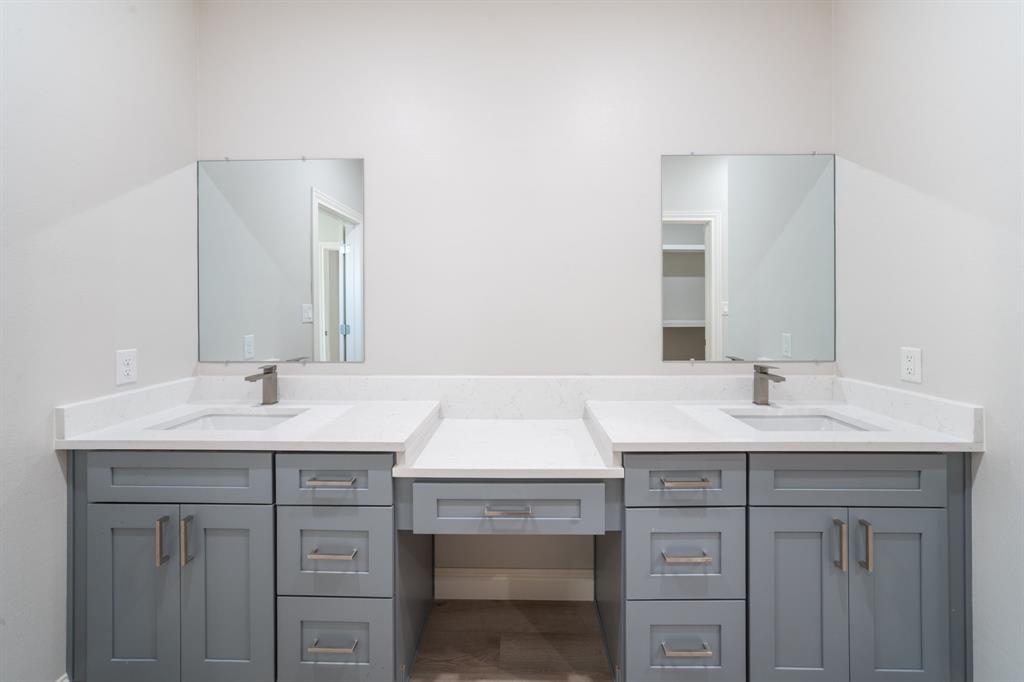 8809 Isom Lane Dallas, TX 75249 - Photo 18 of 40 a bathroom with a sink and a mirror
