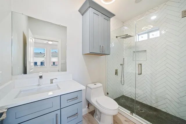 a bathroom with a sink toilet and shower