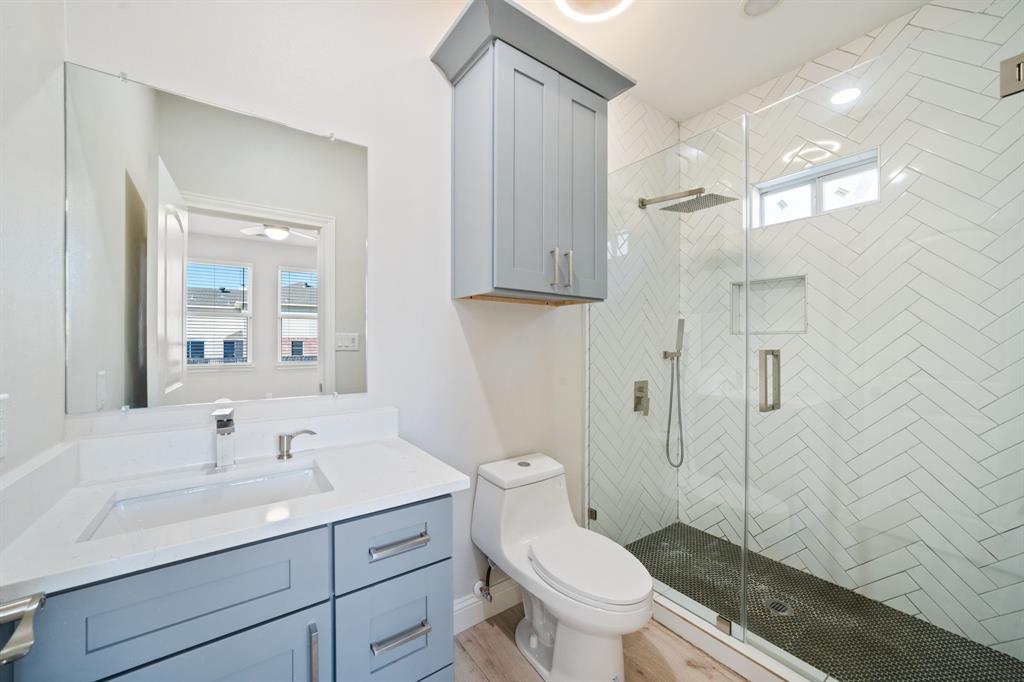 8809 Isom Lane Dallas, TX 75249 - Photo 25 of 40 a bathroom with a sink toilet and shower