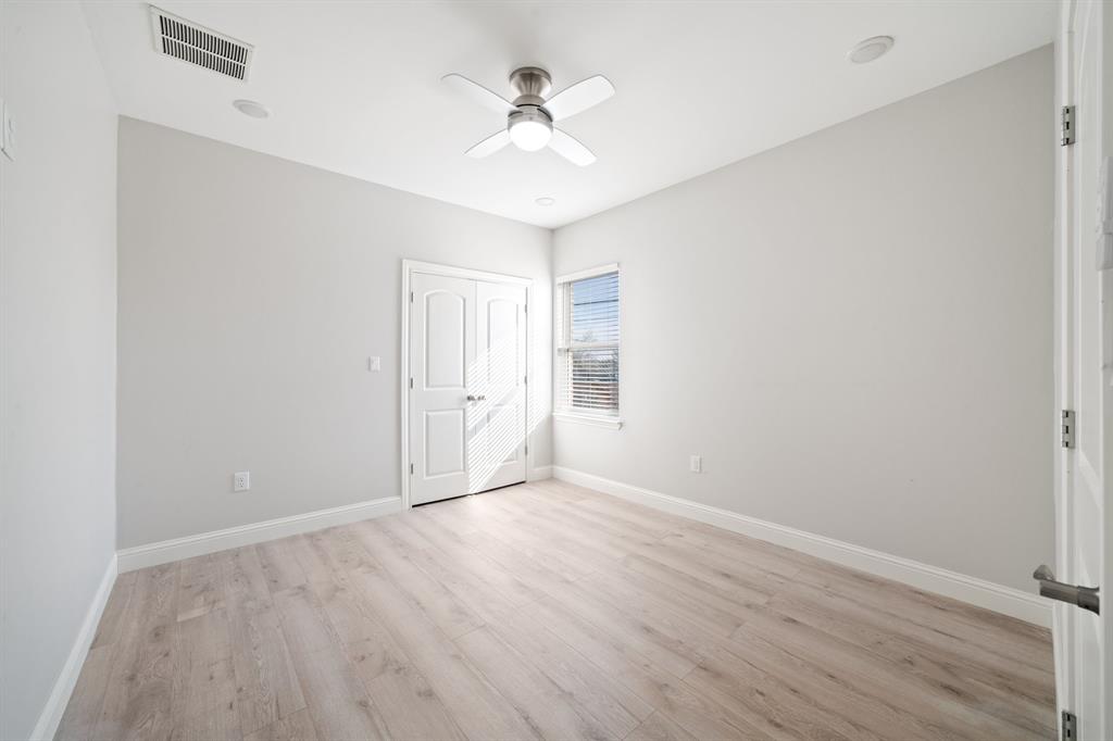 8809 Isom Lane Dallas, TX 75249 - Photo 26 of 40 wooden floor in an empty room with a window