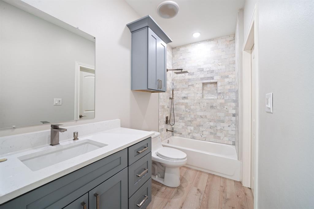 8809 Isom Lane Dallas, TX 75249 - Photo 27 of 40 a bathroom with a sink a toilet and shower