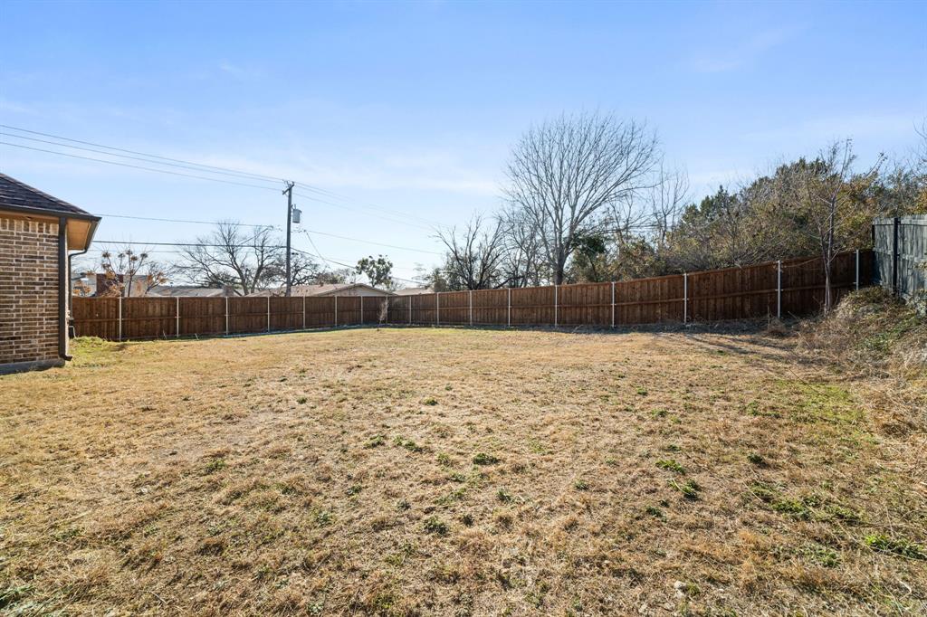 8809 Isom Lane Dallas, TX 75249 - Photo 33 of 40 a backyard of a house with lots of green space