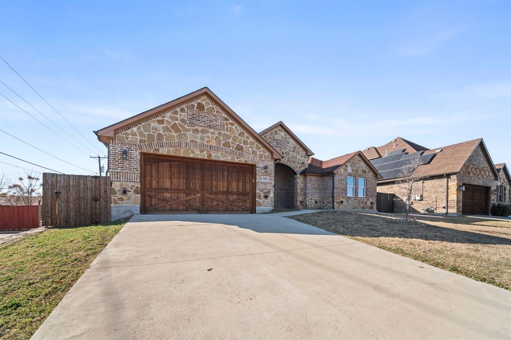 8809 Isom Lane Dallas, TX 75249 - Photo 37 of 40 a front view of a house with a yard and garage