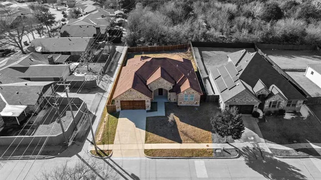 an aerial view of a house with swimming pool and patio