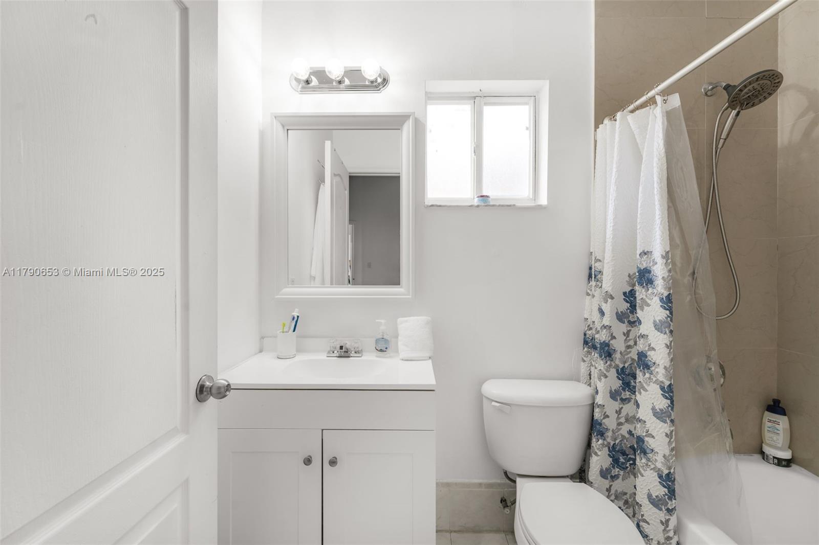 17834 Southwest 144th Court Miami, FL 33177 - Photo 12 of 23 a bathroom with a sink a toilet and shower curtain