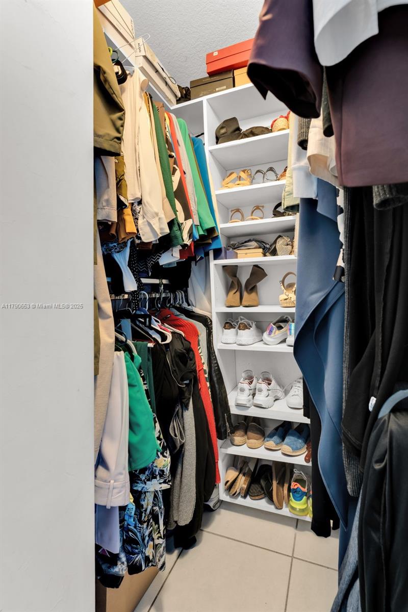 17834 Southwest 144th Court Miami, FL 33177 - Photo 13 of 23 a view of walk in closet with clothes and shoes