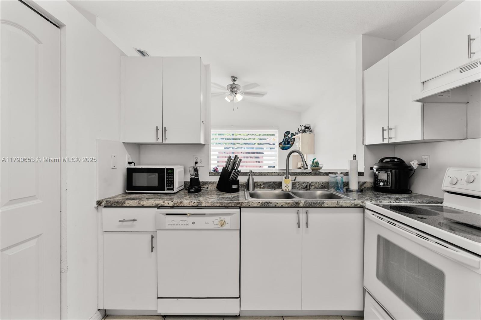 17834 Southwest 144th Court Miami, FL 33177 - Photo 20 of 23 a kitchen with appliances a sink and cabinets