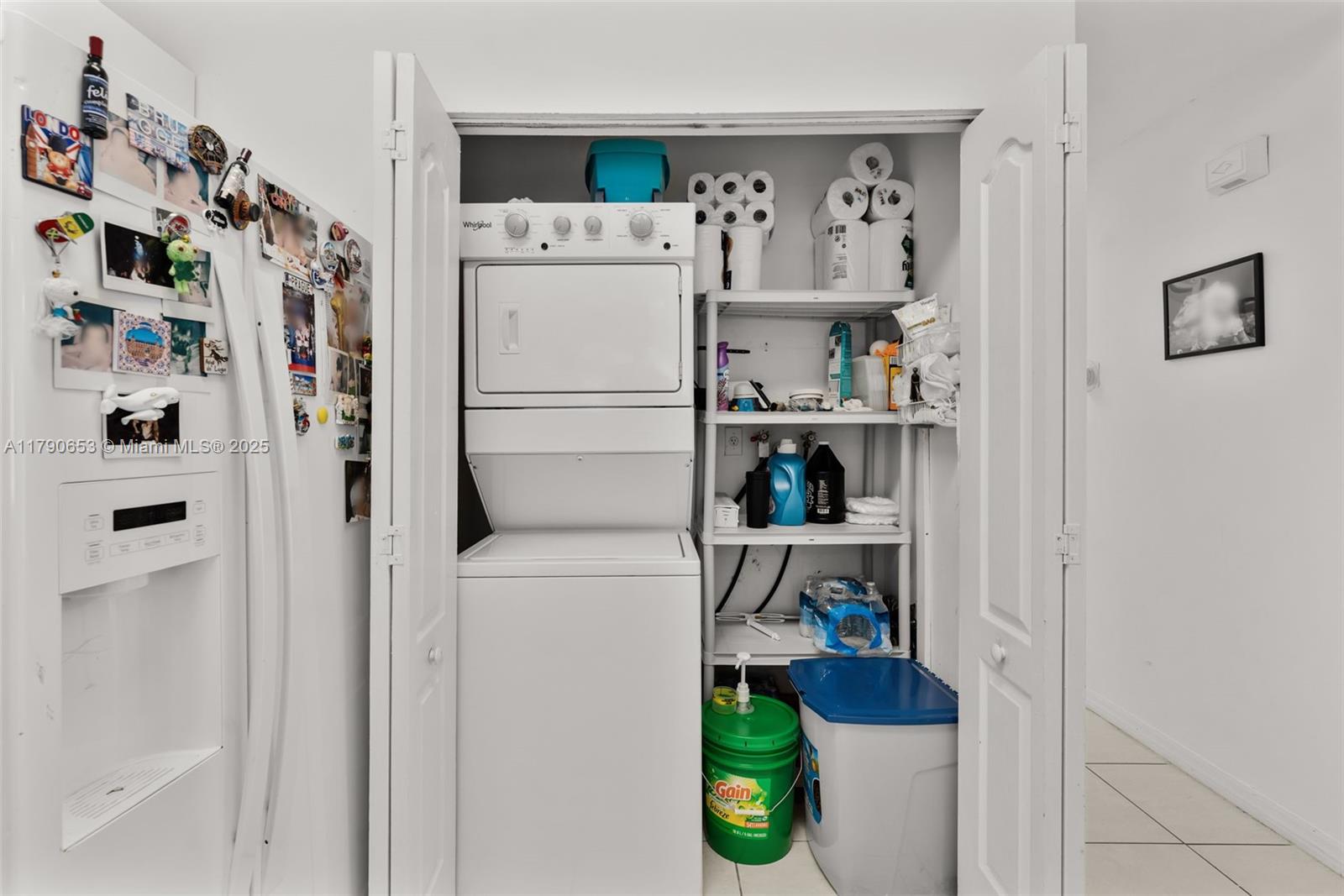 17834 Southwest 144th Court Miami, FL 33177 - Photo 21 of 23 a kitchen with a refrigerator and white cabinets