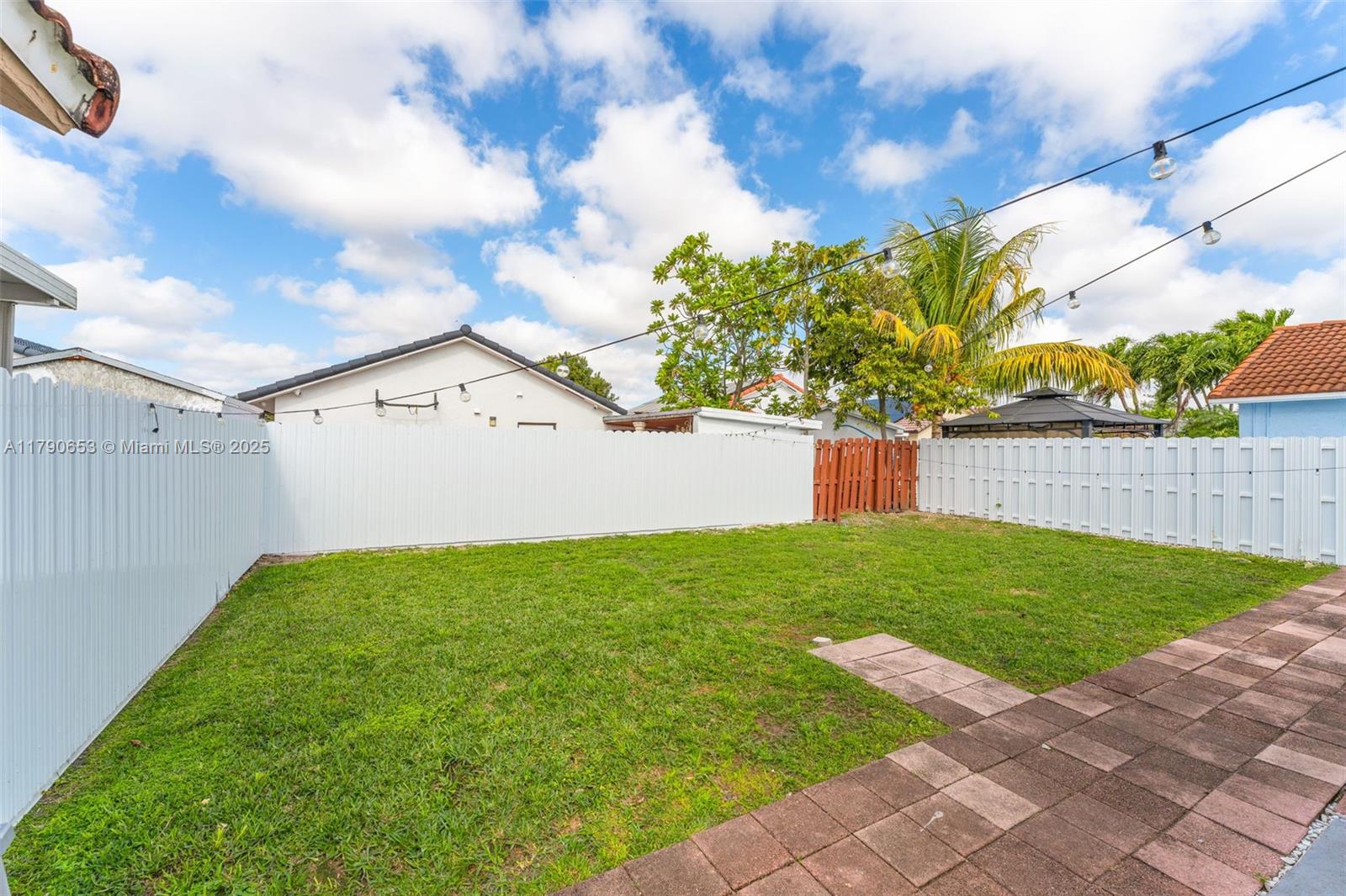 17834 Southwest 144th Court Miami, FL 33177 - Photo 22 of 23 a view of a backyard with wooden fence