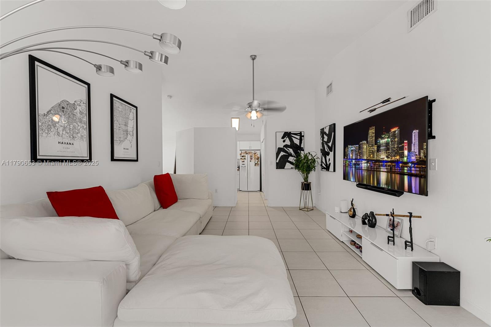 17834 Southwest 144th Court Miami, FL 33177 - Photo 5 of 23 a living room with furniture and a flat screen tv