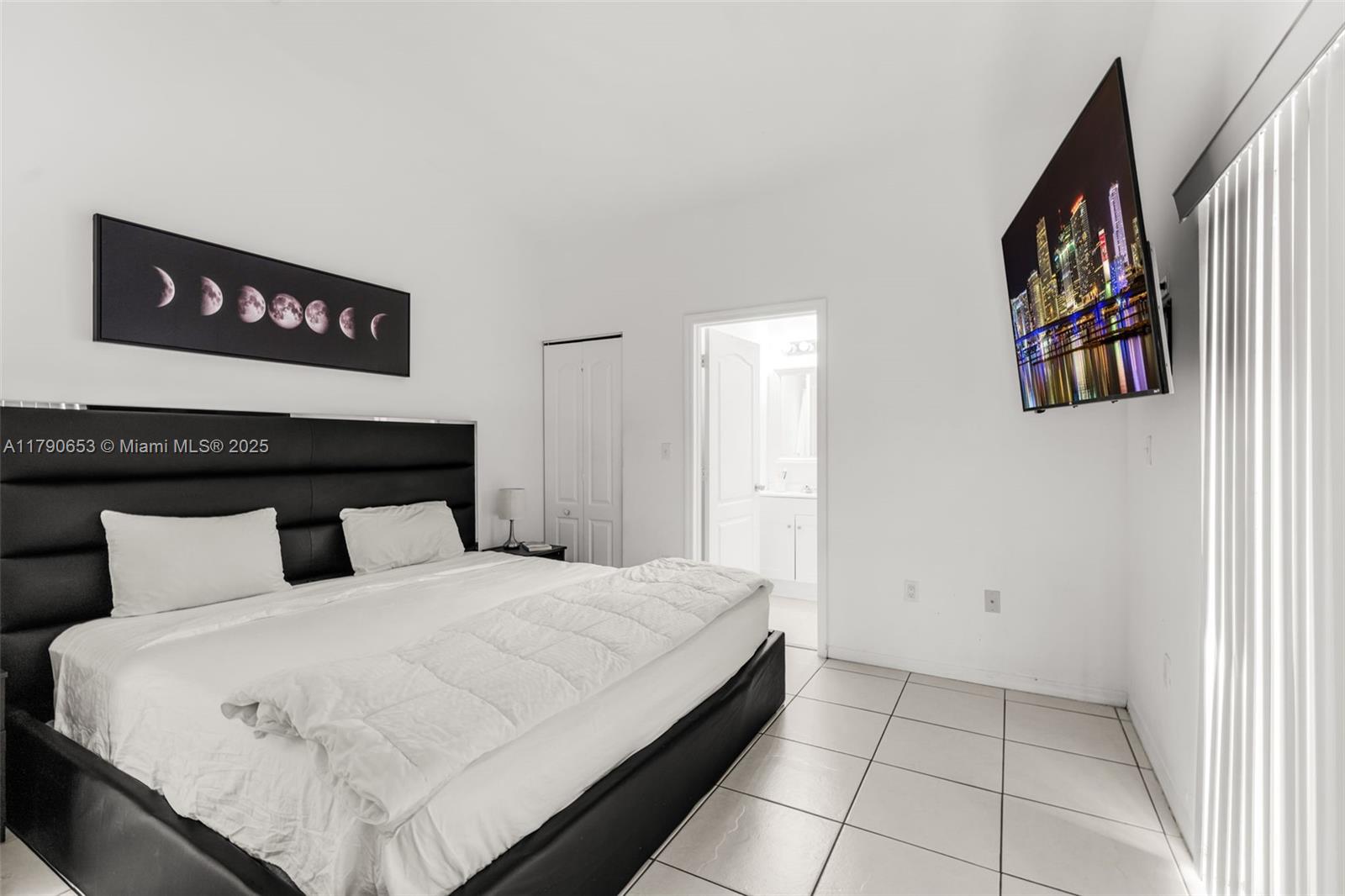 17834 Southwest 144th Court Miami, FL 33177 - Photo 10 of 23 a bedroom with a bed and a walk in closet