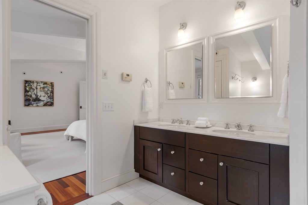 168 Nashawtuc Road Concord, MA 01742 - Photo 28 of 42 a en suite bathroom with a granite countertop sink and a mirror