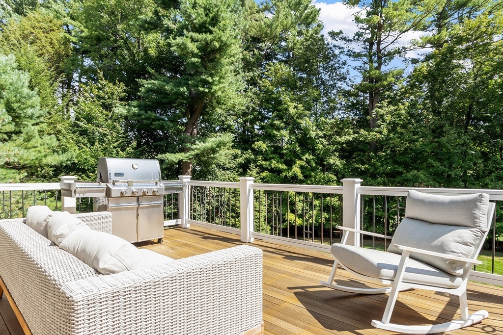 168 Nashawtuc Road Concord, MA 01742 - Photo 3 of 42 a balcony with furniture and a potted plant