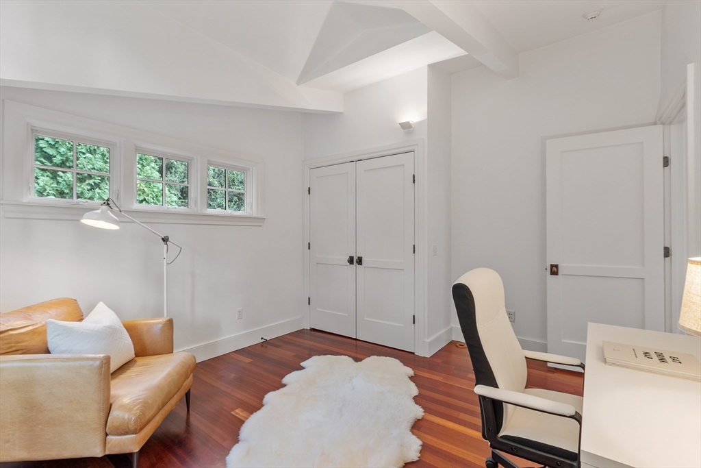 168 Nashawtuc Road Concord, MA 01742 - Photo 34 of 42 a bedroom with a bed and wooden floor