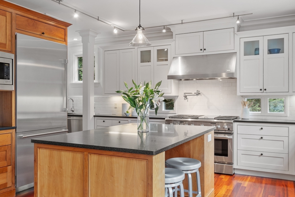 168 Nashawtuc Road Concord, MA 01742 - Photo 5 of 42 a kitchen with stainless steel appliances granite countertop a refrigerator a stove and a sink